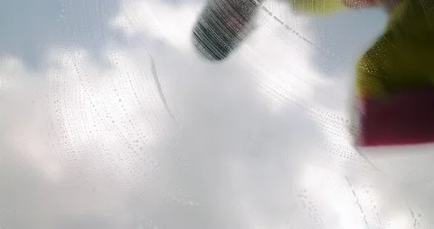 Window cleaner cleans window with foam and puller Stock Footage 190924476