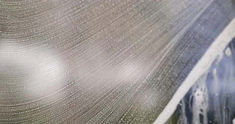 Window cleaner cleans window with foam and puller Stock-Footage 224077401