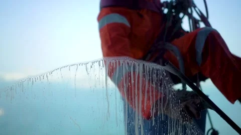 Window cleaner climber washes away soap, shot from inside Stock Footage 224687513