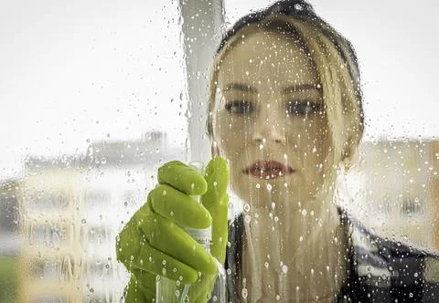 Window cleaner. close up of drops of spray for washing windows on glass. Stock Photos