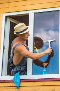 A window cleaner during work, cleaning the glass Stock Photos