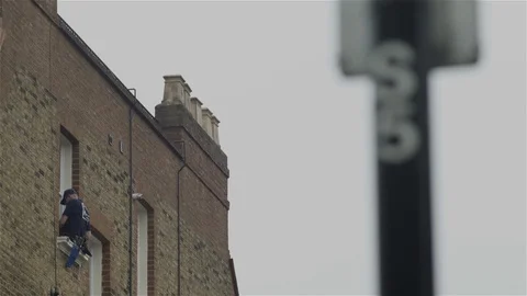 Window cleaner - high up on window ledge Stock Footage 93209009