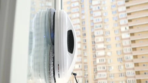 Window cleaner robot cleans the dirt on the window pane. Stock-Footage 244917718