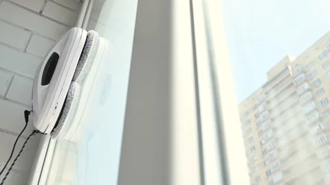 Window cleaner robot cleans the dirt on the window pane. Stock-Footage 244917773