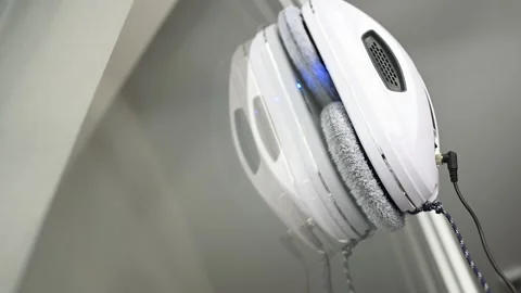 Window cleaner robot cleans the dirt on the window pane. Stock-Footage 244917829