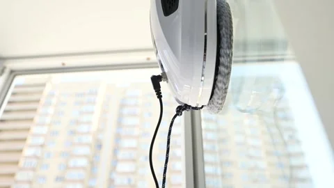 Window cleaner robot cleans the dirt on the window pane. Stock-Footage 247109847