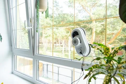 A window cleaner robot cleans windows in a house from the inside. Cleaning .. Stock-Fotos