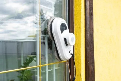 A window cleaner robot cleans windows in a house from the outside. Cleaning.. Foto stock