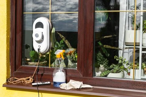 A window cleaner robot cleans windows in a house from the outside. Cleaning.. 写真素材
