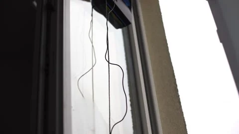A window cleaner robot washes glass against the backdrop of multi-storey Stock Footage 238545984