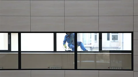 A window cleaner washes a window Stock Footage 57108409
