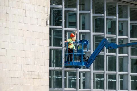 Window Cleaner Working on Building Facade Stock Photos
