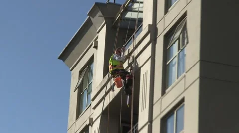 Window cleaner working on top of Vancouver building Stock Footage 52259704