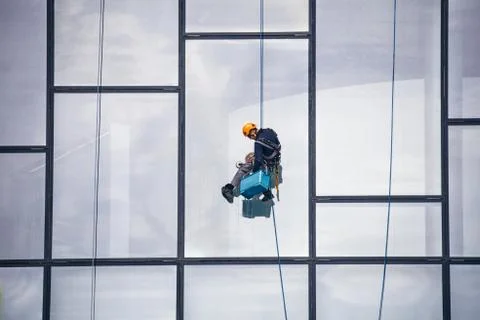 Window Cleaner at Working. Window cleaner, in the suspension system. Industri Stock-Fotos