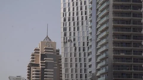 Window cleaners climbing skyscraper Stock Footage 252254223