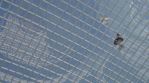 Window cleaners working on a modern glass dome ceiling Stock Footage 330212545
