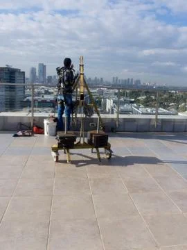 Window cleaning employee with work tools and city background Stock Photos