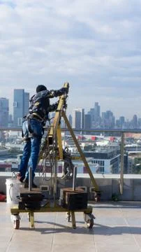 Window cleaning employee with work tools and city background Stock Photos