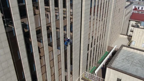 Window cleaning in a massive office building, dangerous height Stock Footage 109330636