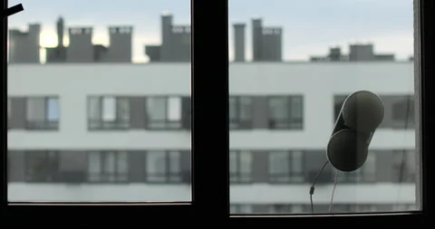 Window cleaning robot in action on glass, modern smart home appliance for Stock Footage 320068240
