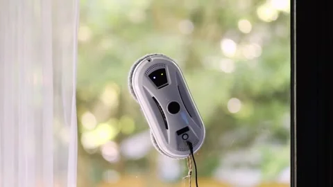 Window cleaning robot on glass with green background. Stock Footage 278295972