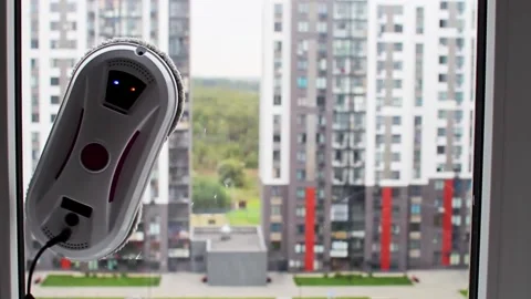 Window cleaning robot. Home work with glass cleaning, technology, gadgets Stock Footage 251859351