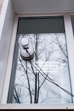 Window cleaning robot operating on glass surface Stock Photos