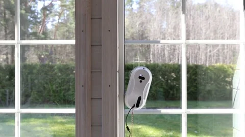 Window cleaning robot. Washing glass using technology in a modern home Stock Footage 238994436