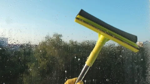 Window cleaning scraper yellow rubber gloves. window cleaning Stock Footage 114654816