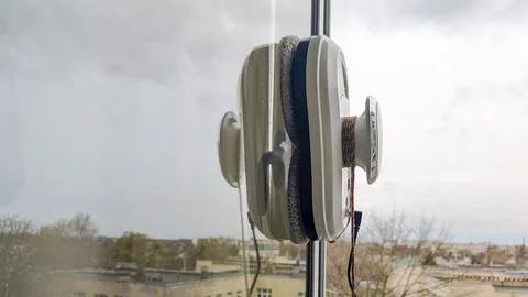 Window cleaning tool with suction cups attached to glass Stock Photos
