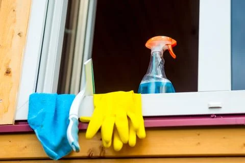 Window cleaning tools on window sill close up Stock Photos