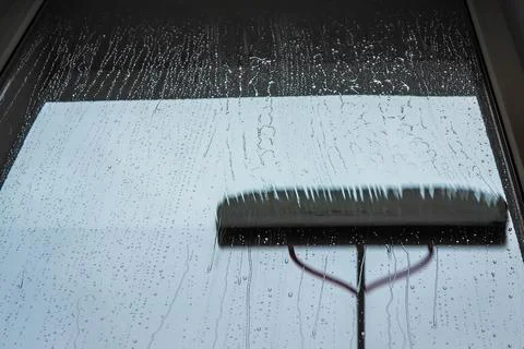 Window cleaning using telescopic water brush and wash system. Commercial window Stock Photos