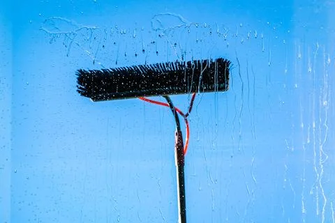 Window cleaning using telescopic water brush and wash system. Commercial window Stock Photos