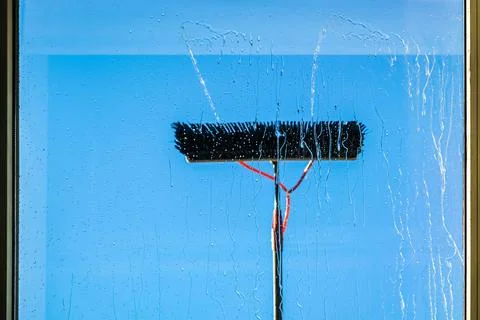 Window cleaning using telescopic water brush and wash system. Commercial window Stock Photos