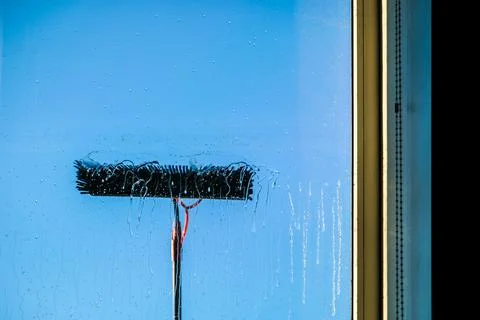 Window cleaning using telescopic water brush and wash system. Commercial window Stock Photos