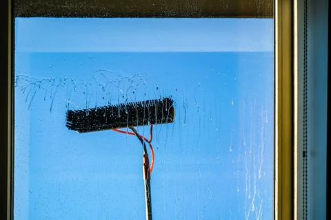 Window cleaning using telescopic water brush and wash system. Commercial window Stock Photos