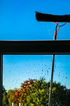 Window cleaning using telescopic water brush and wash system. Commercial window Stock Photos