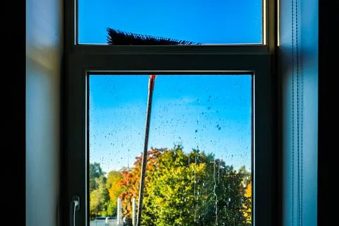 Window cleaning using telescopic water brush and wash system. Commercial window Stock Photos