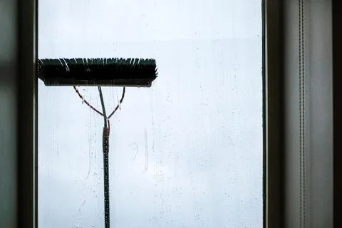 Window cleaning using telescopic water brush and wash system. Commercial window Stock Photos