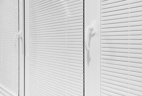 Window with closed horizontal white blinds, side view, interior Stock Photos