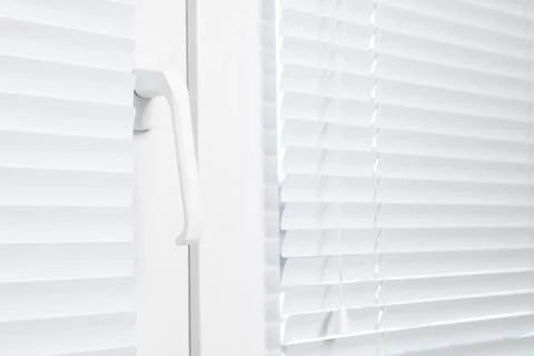 Window with closed white horizontal blinds indoors, closeup Photos