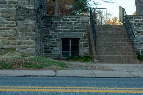 A Window in a Cobblestone Wall With Steps Next to It Stock Photos
