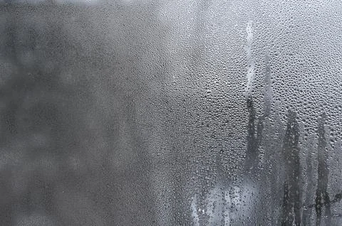 Window with condensation, creating textured background with water droplets .. Stock Photos