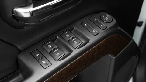 Window control buttons close up 2016 GMC Sierra 2500HD SLE Stock Footage 159860751