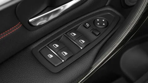 Window control buttons close up 2016 BMW 3-series 330e Stock Footage 159883658