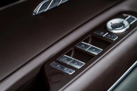 Window control buttons in modern car. Car window control panel. Modern car wi Stock Photos