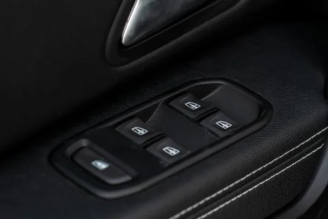 Window control buttons in modern car. Car window control panel. Modern car wi Stock Photos