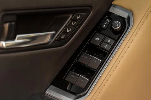 Window control buttons in modern car. Car window control panel. Modern car wi Stock Photos