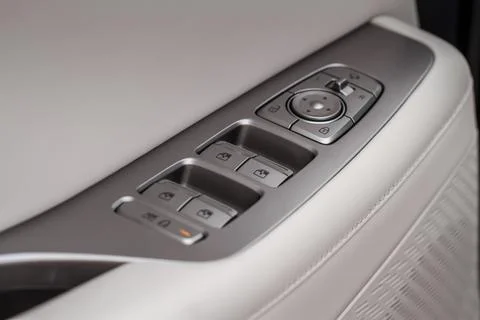 Window control buttons in modern car. Car window control panel. Modern car wi Stock Photos