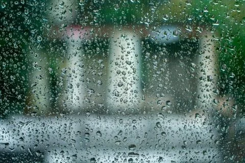 A Window Covered in Small Raindrops With Symmetrical Shapes Behind It Stock Photos